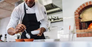 Hospitality worker chef preparing meal