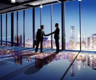 Two men shaking hands in building